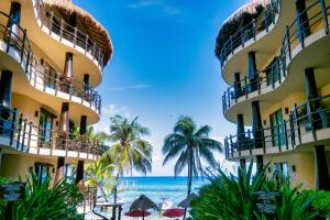 a view of the ocean from the beach in front of a hotel at El Taj Oceanfront and Beachside Condo Hotel in Playa del Carmen