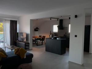 a living room and kitchen with a couch and a table at La Familia in Blato
