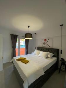 a bedroom with a large white bed with a window at La Familia in Blato +13 photos