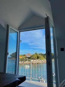 a room with a window with a view of the water at La Familia in Blato
