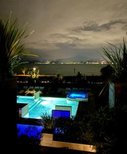 a swimming pool with a view of the ocean at night at Lake Garda Lovers Luxury in Peschiera del Garda