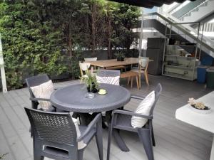 a patio with a table and chairs on a deck at Buddies Charm Apt - Self Catering in Aveiro