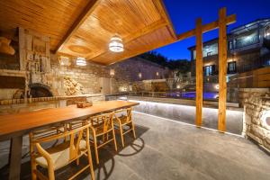 an outdoor patio with a wooden table and chairs at Asion Lithos Villas & Suites with Private Pools in Kato Asites +41 photos