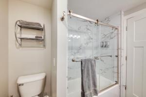 a bathroom with a toilet and a glass shower at Waterfront Sandpoint Condo Lake Access! in Sandpoint +21 photos