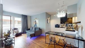 a living room with a dining table and a kitchen at Apartament Dmowskiego 1B Wielka Wyspa 900 steps to Market in Wrocław +7 photos