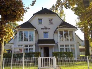 a white house with a fence in front of it at Haus Margarete by Rujana in Binz