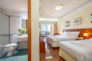Postel nebo postele na pokoji v ubytování Porto Alegre Hotel