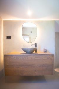 a bathroom with a sink and a mirror at L'indret del Pedraforca Adults Only in Saldés +76 photos