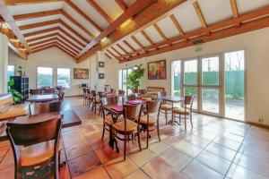 a dining room with tables and chairs and windows at Brit Hotel Confort Castres in Castres