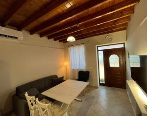 a living room with a couch and a table at Aegean Dream Residence in Plomari