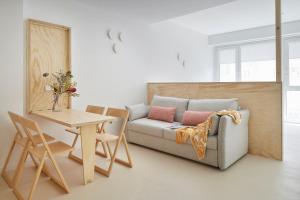 a living room with a couch and a table at FeelFree STAYS Antiguo in San Sebastián