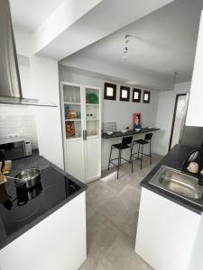 a kitchen with a counter top and a table at AT Paseo Ficus Centenario in Almería