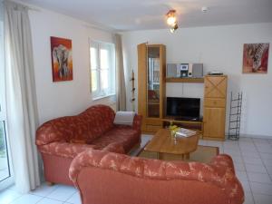 a living room with a couch and a table at Residenz Binz by Rujana in Binz