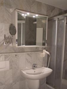 a bathroom with a sink and a mirror at Residenz Binz by Rujana in Binz