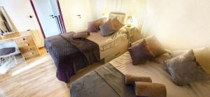 deux lits dans une petite pièce avec dans l'établissement Au 26BIS, 2 Appartements MONTREUX, 1 Apartment niveau 0 et un autre appartement duplex niveau 1 et 2, 15 minutes à pieds du centre de Montreux, Lac Léman, idéal pour balades en ville, Montagne, festivals, Casino, plages, ski, Fredy Mercury, Marché de Noël, à Montreux