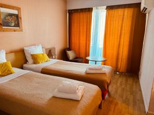a hotel room with two beds and a window at Hotel Panorama in Grasse