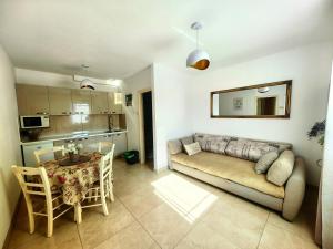 a living room with a couch and a table at Apartments Lea with pool 2 in Malinska