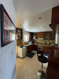 a kitchen with a refrigerator and a chair in it at Apartment Bungalow in Mauritius, Flic En Flaq in Flic-en-Flac