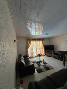 a living room with a couch and a table at Apartment Bungalow in Mauritius, Flic En Flaq in Flic-en-Flac +15 photos