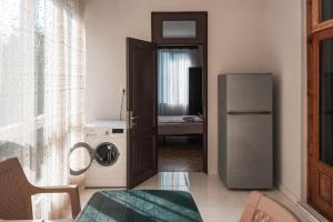 a kitchen with a refrigerator and a washing machine at Nargiz's Guest House in Batumi