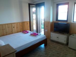 Postel nebo postele na pokoji v ubytování Rony Hotel