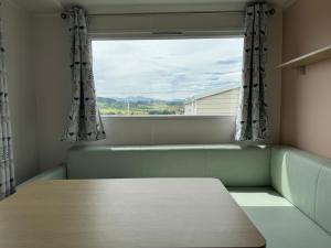 a room with a table and a window at Altamira Camping in Queveda +25 photos