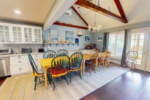 a kitchen with a dining room table and chairs at Bayview in Truro