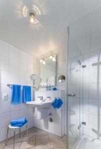 a bathroom with a sink and a shower at Villa Aesculap by Rujana in Binz