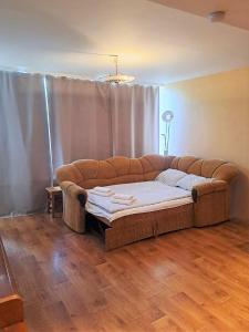 a couch sitting in a living room with a table at Sunny flat 250m from the beach in Liepāja