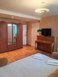 a living room with a bed and a piano at Sunny flat 250m from the beach in Liepāja