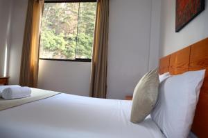 Letto o letti in una camera di Fenix Hotel Machupicchu