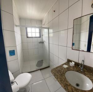 a white bathroom with a sink and a shower at Brothers Suites Centro Búzios in Búzios +50 photos
