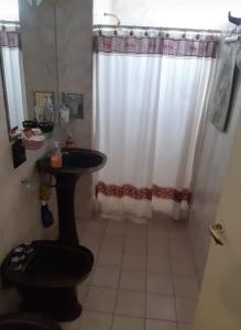 a bathroom with a sink and a shower curtain at Sandy in Cordoba