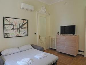 a bedroom with a bed and a flat screen tv at Inappartamento La Pepita Luxury in Turin