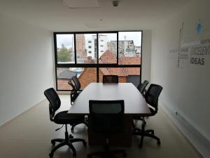 a conference room with a table and chairs in front of a window at Nice flat in financial heart of Bogotá in Bogotá +34 photos