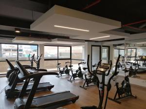 a gym with a lot of treadmills and elliptical machines at Nice flat in financial heart of Bogotá in Bogotá