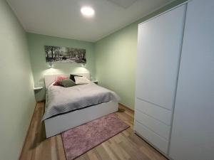 a small bedroom with a bed and a closet at Apartament Pastelowy in Głuszyca