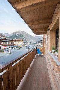 a wooden balcony with a view of a street at Appartamento Dina in Livigno