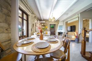 a large dining room with a table and chairs at Asion Lithos Villas & Suites with Private Pools in Kato Asites