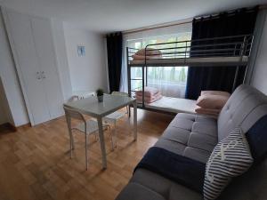 a living room with a couch and a table and a bunk bed at Wypoczynkowo in Stegna