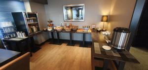 a room with a counter with food on it at Logis Hôtel l'Albatros in Damgan