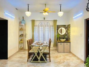 a dining room with a table and chairs at Padmanabham Villa in Trivandrum