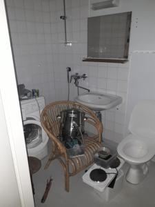 a small bathroom with a sink and a toilet at rowhouse for 4 people with 2 rooms in Kemi