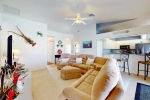 a living room with two couches and a kitchen at Sunny Way in Rotonda West