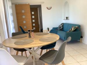 a living room with a table and chairs and a couch at Le Petit Jardin in Estampes +6 photos