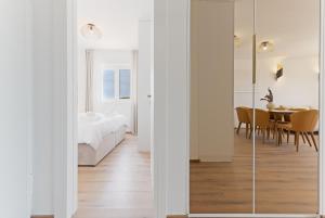 a bedroom with a bed and a dining room at Lush Suites in Trogir
