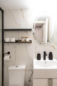 a bathroom with a white sink and a mirror at Banffy's little house in Cluj-Napoca +7 photos