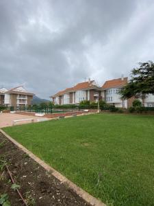 a large grassy yard in front of some houses at Apartamento con vistas al mar playa Berria-Santoña in Santoña