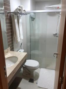 a bathroom with a shower and a toilet and a sink at Park Veredas Flat Service Rio Quente - GO Apto 416 in Rio Quente