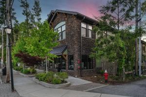 a brick building with a red fire hydrant in front of it at Franklin on Main in Blowing Rock